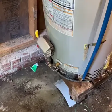 Rusted base and worn wood stand at the bottom of a gas water heater